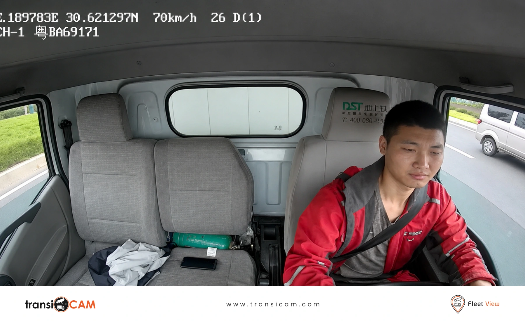 Australian truck driver operating a heavy vehicle with an in-cabin driver fatigue monitoring camera.